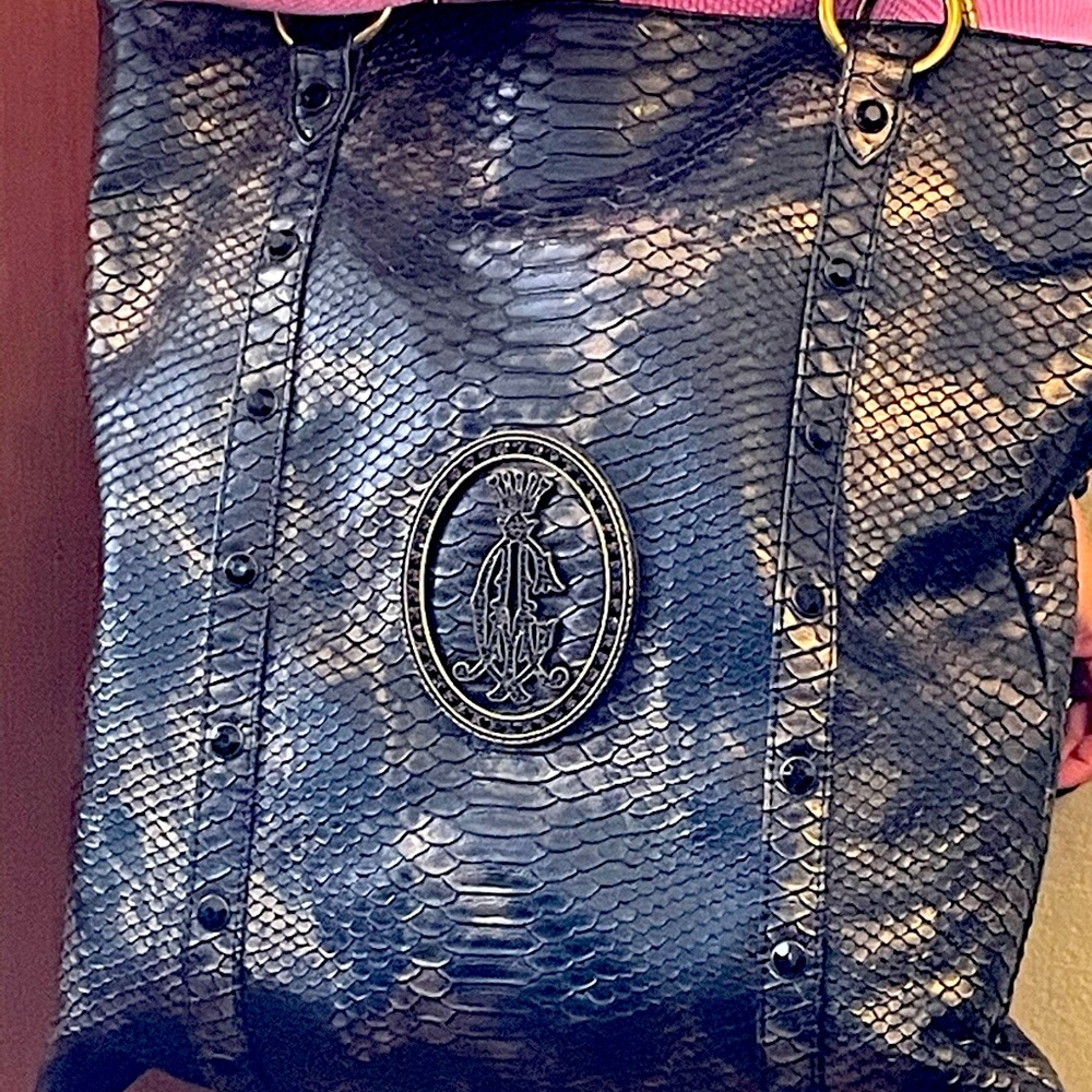 Black and gold Christian Aidigier satchel.